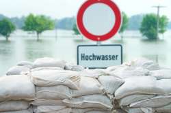 Foto: Sandsaecke und Schild mit Aufschrift Hochwasser